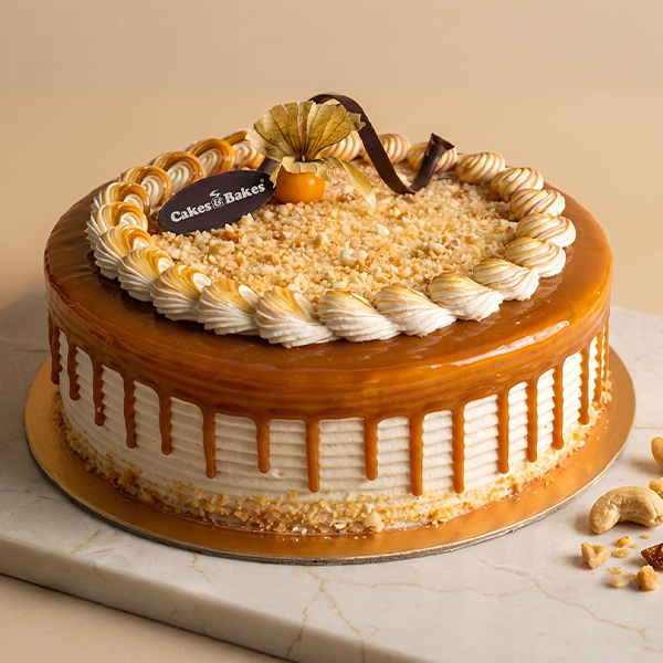 Butterscotch Marble Cake from Cakes and Bakes Bakery Dubai featuring soft vanilla sponge, whipped cream, homemade caramel drizzle and crunchy roasted cashew nougat.
