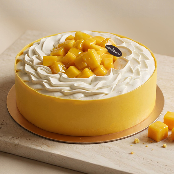 Mango Mousse Cake from Cakes and Bakes Bakery Dubai featuring soft vanilla sponge, mango filling and fresh mango cubes for a fruity birthday cake.