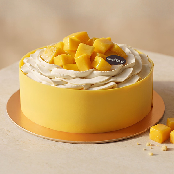 Mango Mousse Cake from Cakes and Bakes Bakery Dubai featuring soft vanilla sponge, mango filling and fresh mango cubes for a fruity birthday cake.