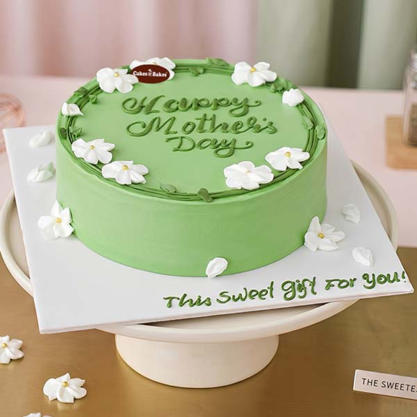 Mother’s Day Floral Green Cake with white flowers by Cakes and Bakes Dubai