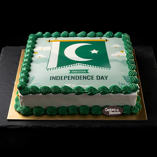 Pakistan Flag Independence Day Cake with edible Pakistani flag print, crescent and star design, Independence Day lettering, and green buttercream rosette borders by Cakes and Bakes Bakery Dubai.