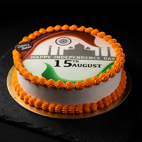 Patriotic Indian Celebration Cake with edible Indian tricolor design, Ashoka Chakra, Taj Mahal silhouette, Happy Independence Day 15th August message, and orange piped borders by Cakes and Bakes Baker