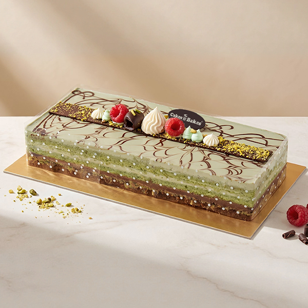 Pistachio Chocolate Cake from Cakes and Bakes Bakery Dubai featuring pistachio sponge, pistachio cream, rich chocolate ganache and a crunchy layer.